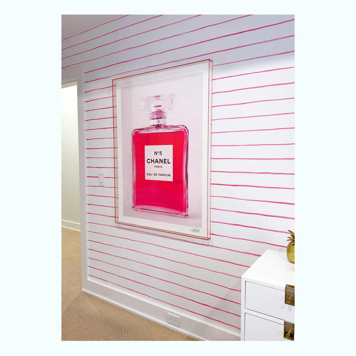 channel bottle with pink liquid inside