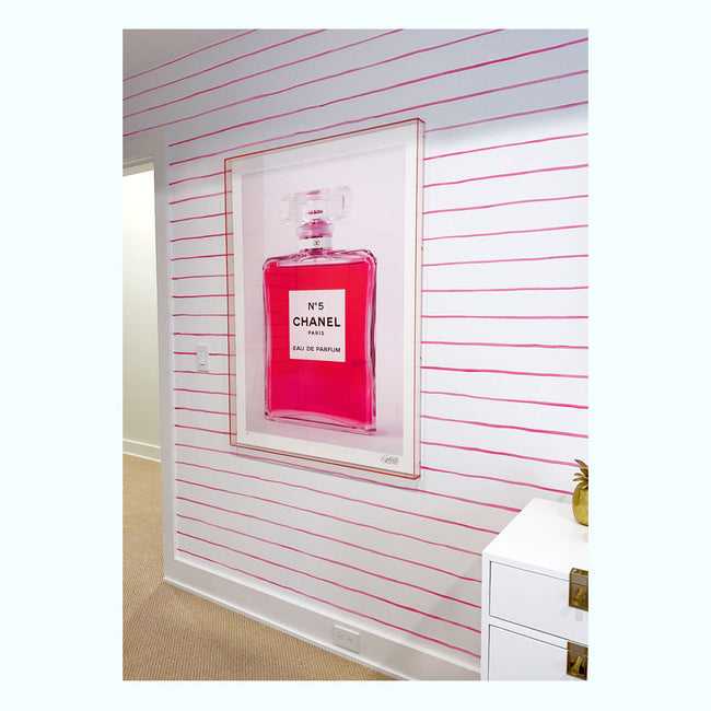 channel bottle with pink liquid inside