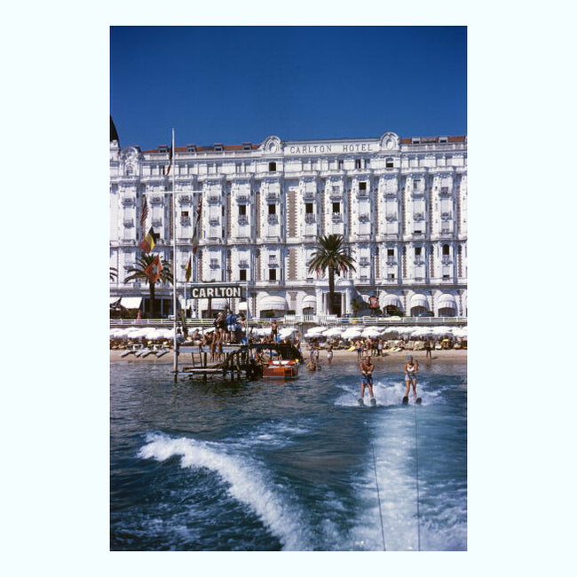 art print of a hotel in front of the sea